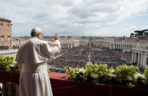 Pope Francis waving to the Easter Sunday mass crowd at the Vatican in 2018.