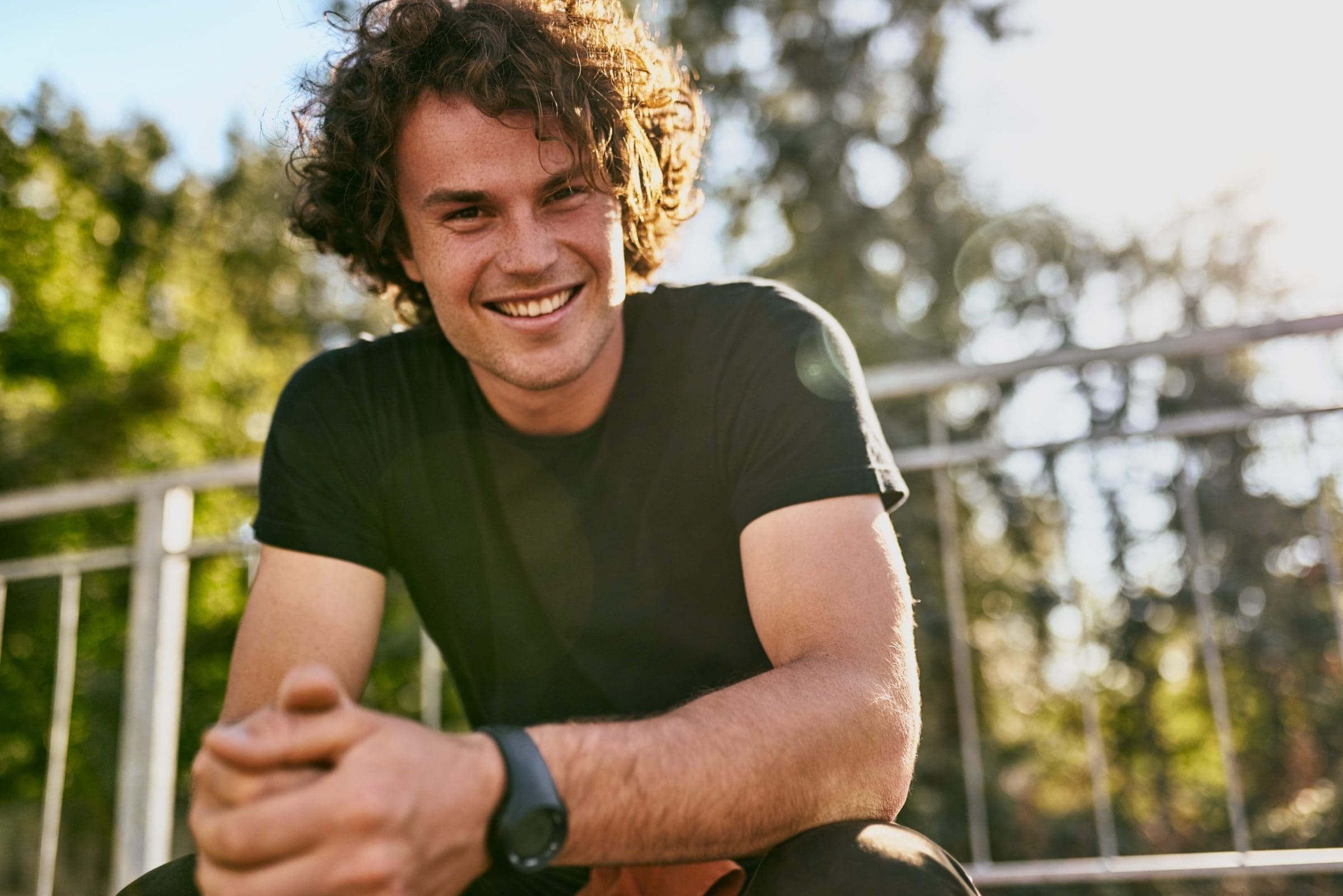 Portrait of smiling cheerful young man wears black t-shirt and w