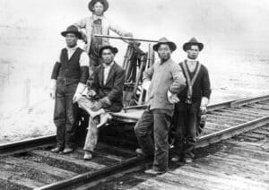 Picture of Chinese American workers on a railroad car as they built the Transcontinental Railroad. 