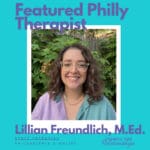A smiling person with curly brown hair and clear glasses stands in front of green foliage. Text on the image reads: “Featured Philly Therapist. Lillian Freundlich, M.Ed. Staff Therapist. Philadelphia & Online.” Council for Relationships logo appears in the lower right corner. Lillian Freundlich is a CFR Staff Therapist who offers person-centered therapy, therapy for young adults, and is an LGBTQ affirming therapist.