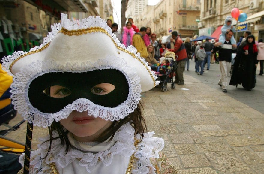 A girl wearing a mask for Purim.