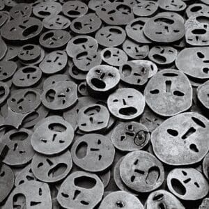 Iron face masks in a pile representing Holocaust victims