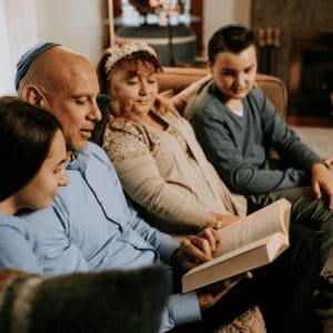 Image of a Jewish family reading the Torah